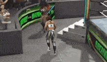 a woman is walking on a wrestling ring in a video game .