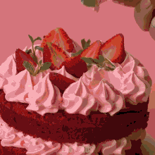 a red velvet cake with pink frosting and strawberries on top of it