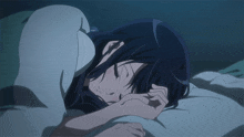 a girl is sleeping in a bed with her head on a pillow