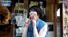 a woman making a funny face in front of a stardom store