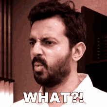 a man with a beard is making a funny face with the words what written on his face