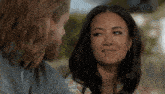 a man and a woman are looking at each other and smiling