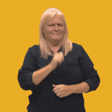 a woman wearing a black shirt is making a funny face