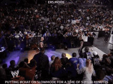 a crowd of people watching a wrestling match with the words putting #chat on slowmode for a time of 5 minutes