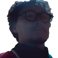 a man with glasses and a beard looks up at the sky