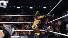 a woman in a wrestling ring with a w logo on the ring