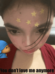 a girl with stars painted on her face and the words " you don 't love me anymore " on the bottom