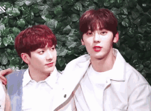 two boys are standing next to each other with the word nuest on the bottom