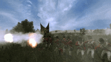 a group of soldiers standing in a field with a flag flying in the background