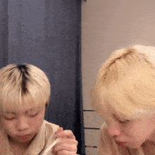 a man with blonde hair is holding a spoon in his mouth