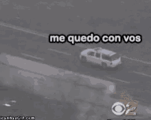 a white truck is driving down a highway next to a cbs sign