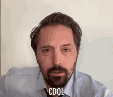 a man with a beard is wearing a shirt and tie and the word cool is on his face