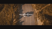 an aerial view of a car driving down a road with the words miki lux head admini below it
