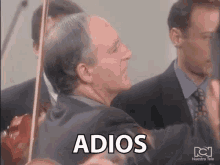 a man in a suit with the word adios written on his face
