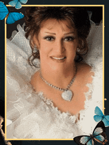 a woman wearing a white dress and a heart shaped necklace is surrounded by blue butterflies