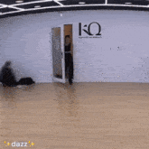 a man is dancing in a dance studio with dazz written on the bottom right