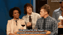 a group of people sitting around a table with one saying i 'm gonna hit the head