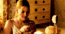 a woman is looking at her phone and smiling