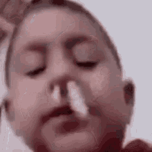 a close up of a person blowing their nose with a nasal spray .