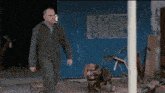 a man walking past a sign that says do n't block