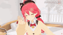 a girl with red hair and a cat hat is sitting on a bed in a room