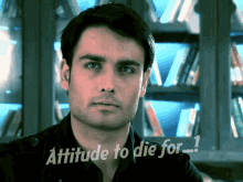 a man in front of a bookshelf with the words attitude to die for written below him