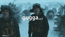 two soldiers are standing in the snow and the word gugga is on the screen