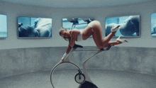 a woman in a white bikini is kneeling down on a bike