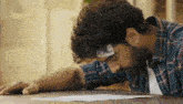 a man with a bandage on his forehead is laying down on a table