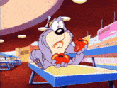 a cartoon character is sitting on a table eating tomatoes in a cafeteria .
