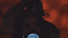 a man with a chain around his neck is wearing a mask that says skull