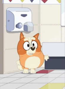 a cartoon dog is standing in a bathroom next to a hand dryer .