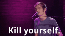 a man singing into a microphone with the words kill yourself written below him