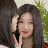 a woman is touching another woman 's face with her finger