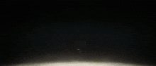 a close up of a glowing object in the dark with a blurred background .
