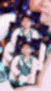 a blurry picture of a person giving a peace sign with their hand