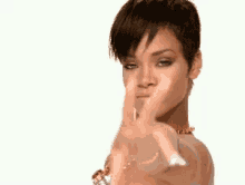 a woman is pointing her finger at the camera .