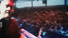 a man is standing in front of a crowd of people