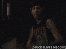 a blurred image of a man with the words deuce 9 lives discord on the bottom