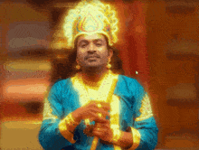 a man in a blue and gold costume with a gold crown