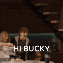 a blurred image of people sitting at a table with the words hi bucky written in white