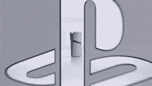 a close up of a playstation logo on a gray surface