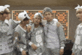 a group of young men are posing for a picture with one wearing a shirt that says 2dp