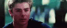 a close up of a man 's face with a tear running down his face .