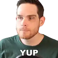 a man with a beard is wearing a green shirt with the word yup written on it