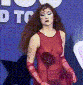 a woman in a red dress and red gloves