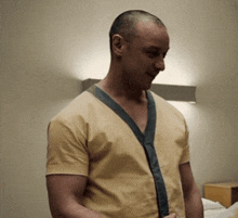 a man in a yellow shirt with a blue collar