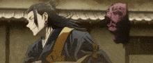 a man in a kimono is standing next to a purple mask
