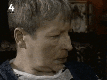 a close up of a person 's face with the number 4 on the bottom right