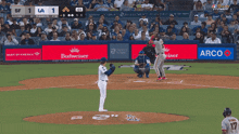 a baseball game is being played with a budweiser ad